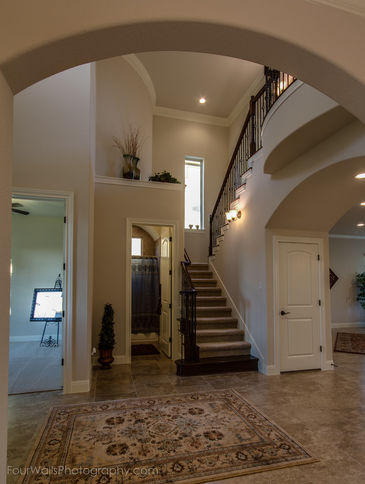 Staircase - traditional carpeted metal railing staircase idea in Austin with carpeted risers