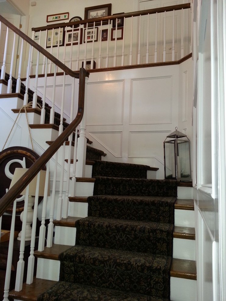 Example of a large classic wooden l-shaped wood railing staircase design in Jacksonville with painted risers