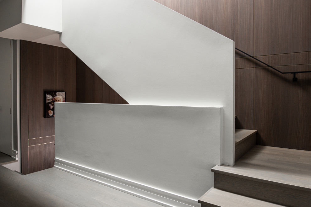 Example of a large trendy wooden l-shaped metal railing staircase design in San Francisco with wooden risers