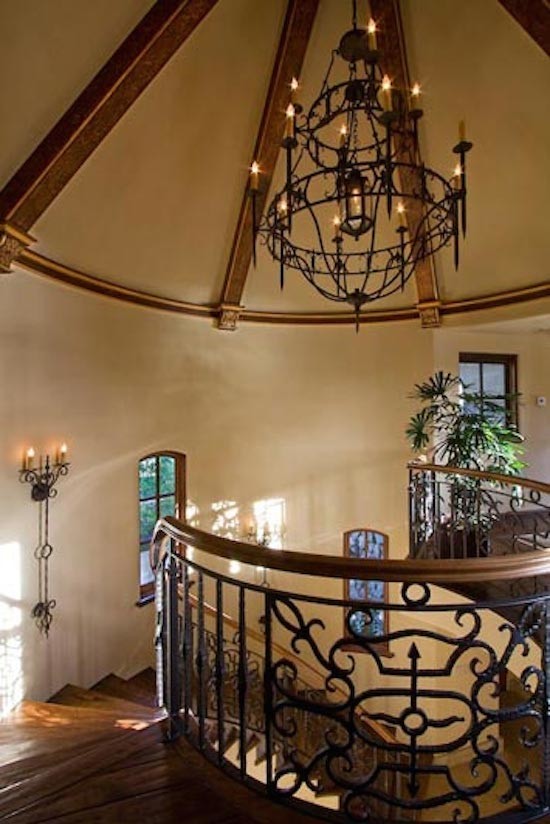 Large elegant wooden curved staircase photo in Sacramento with tile risers
