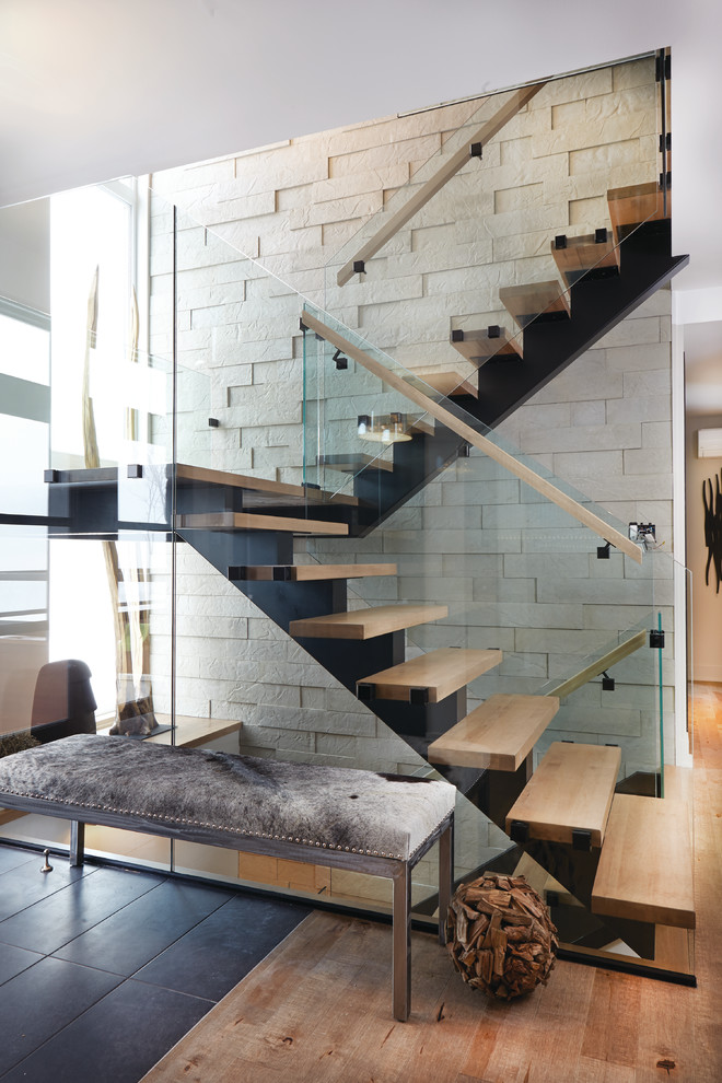 Example of a mid-sized minimalist wooden floating open staircase design in Montreal