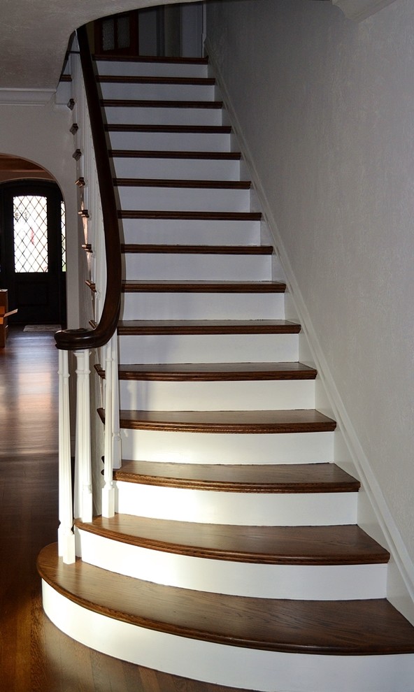 This is an example of a medium sized classic wood straight staircase in St Louis with painted wood risers.