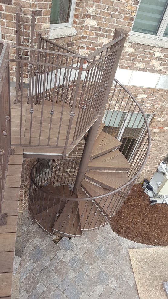 Classic wood spiral staircase in Chicago with open risers.