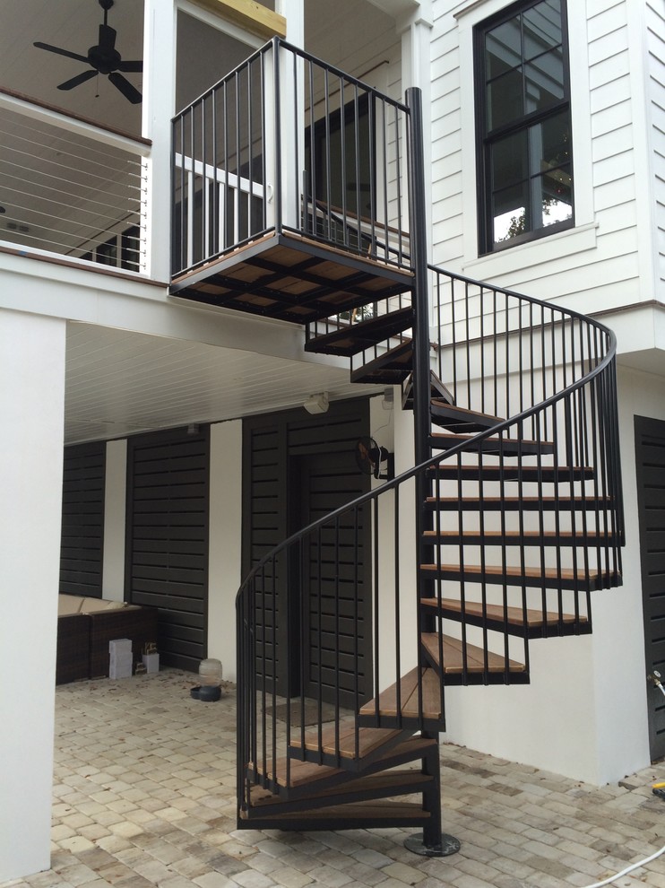 Inspiration for a large contemporary wood spiral staircase in Charleston with wood risers.