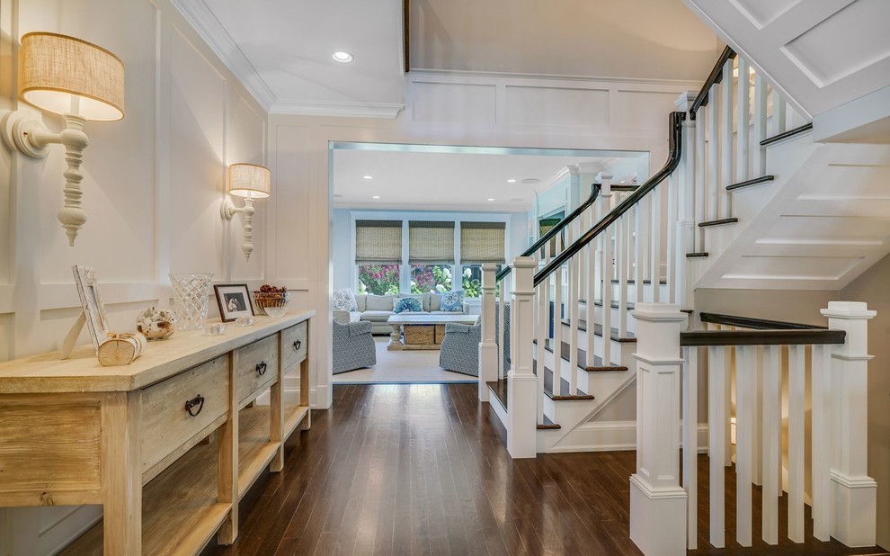 Inspiration for a timeless wooden u-shaped wood railing staircase remodel in Other with wooden risers