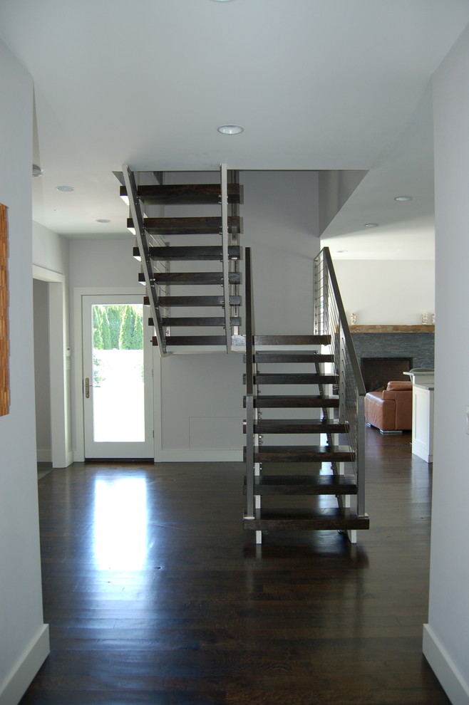 Staircase - transitional wooden floating open staircase idea in New York