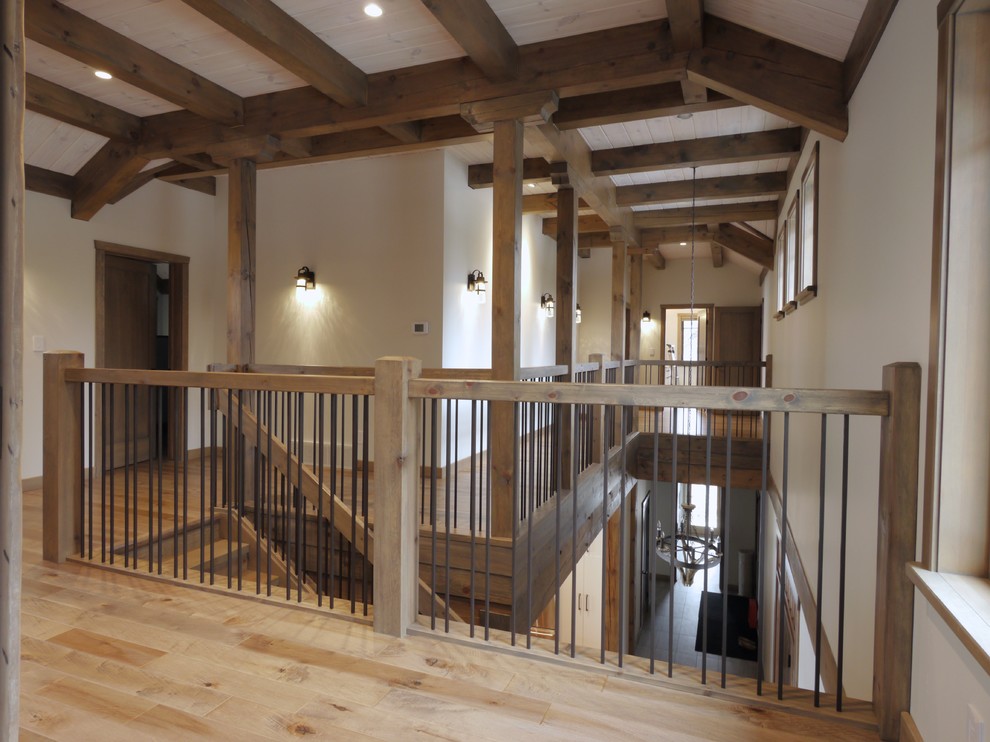 Ejemplo de escalera en L rústica grande con escalones de madera, contrahuellas de madera y barandilla de madera