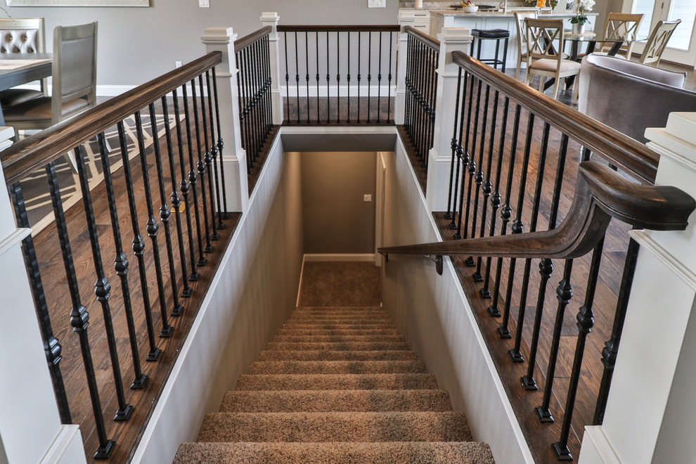 Photo of a large classic carpeted l-shaped metal railing staircase in St Louis with carpeted risers.