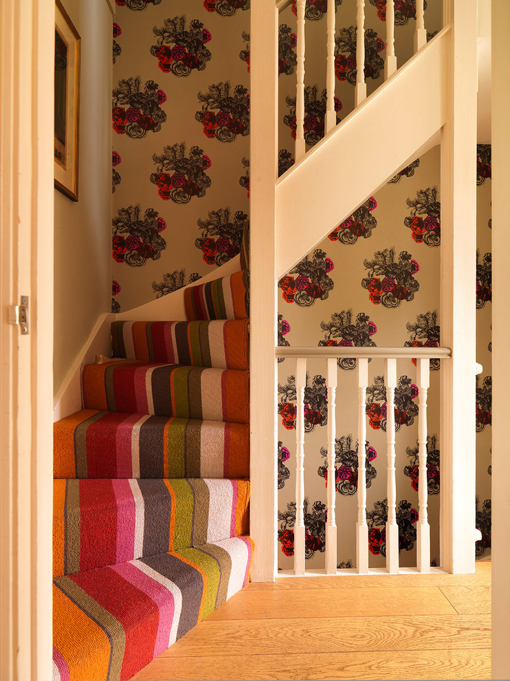 Inspiration for a small carpeted curved staircase in London with carpeted risers.