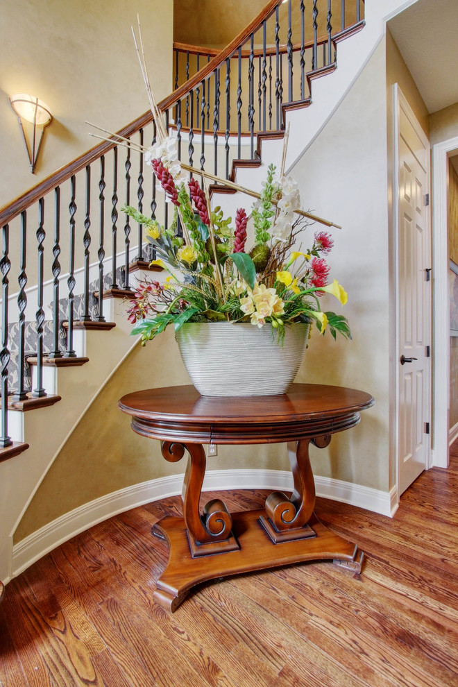 Large transitional carpeted curved staircase photo in Kansas City with carpeted risers