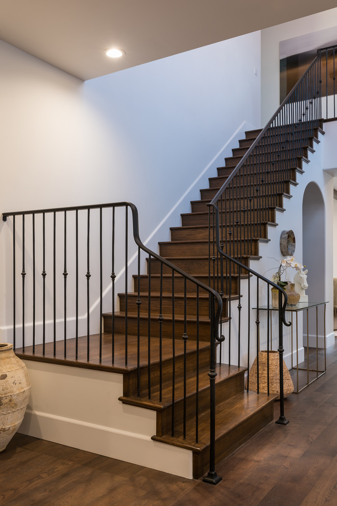 Example of a tuscan wooden l-shaped staircase design in Los Angeles with wooden risers