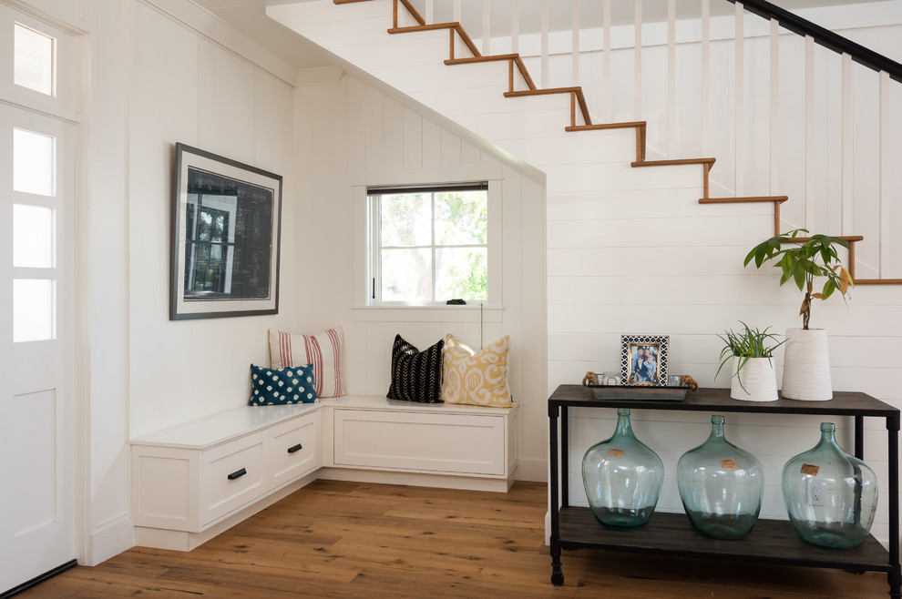 Example of a farmhouse wooden staircase design in San Diego
