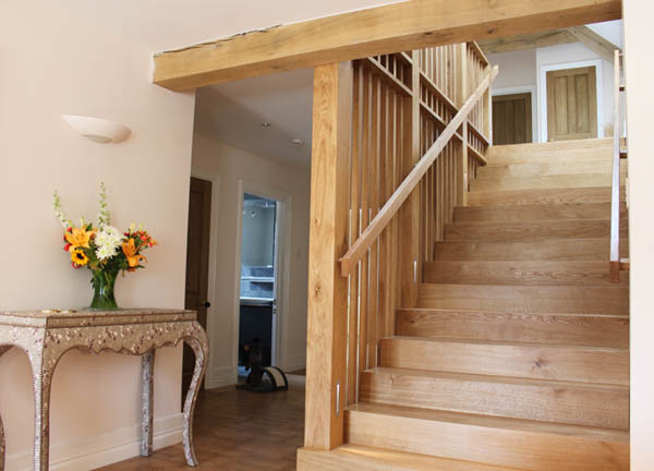 Design ideas for a large wood straight wood railing staircase in Wiltshire with wood risers.