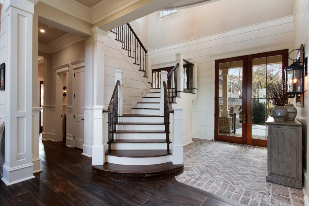 This is an example of a large country wood u-shaped mixed railing staircase in Atlanta with painted wood risers.