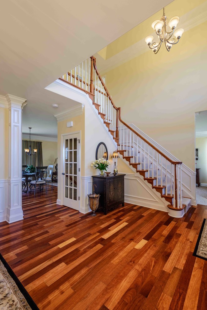 Medium sized classic wood l-shaped staircase in Philadelphia with painted wood risers.