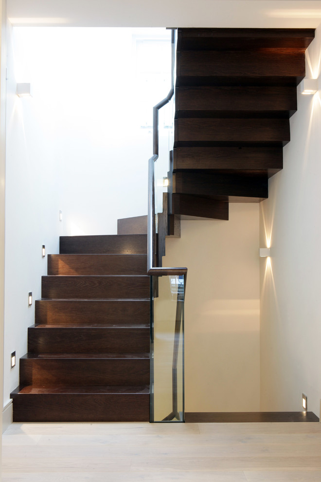 Photo of a contemporary wood u-shaped staircase in London with wood risers.