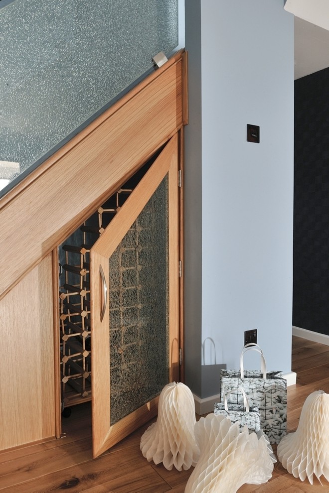 Inspiration for a medium sized contemporary glass curved metal railing staircase in Other with wood risers.
