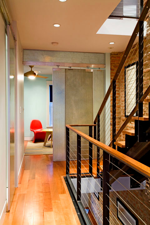 Example of a trendy wooden straight staircase design in Baltimore with metal risers