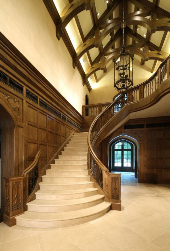 На фото: изогнутая лестница среднего размера в классическом стиле с ступенями из плитки, подступенками из плитки и деревянными перилами