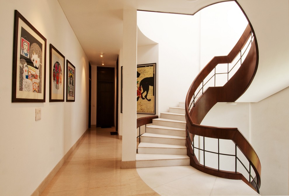 Diseño de escalera curva de estilo zen con escalones con baldosas, contrahuellas con baldosas y/o azulejos y barandilla de madera