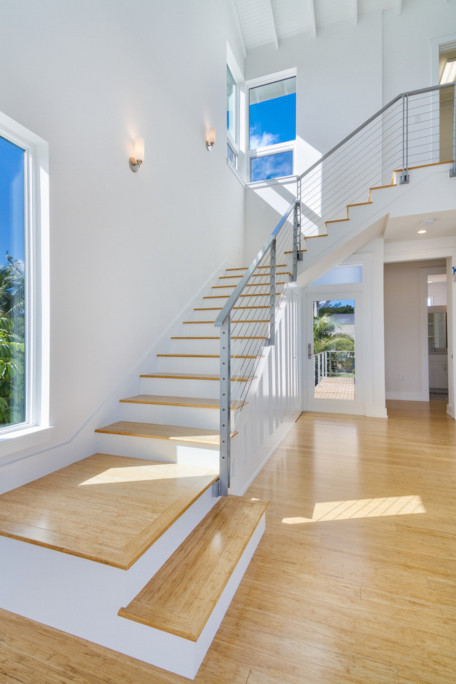 Medium sized contemporary wood u-shaped staircase in Tampa with painted wood risers.