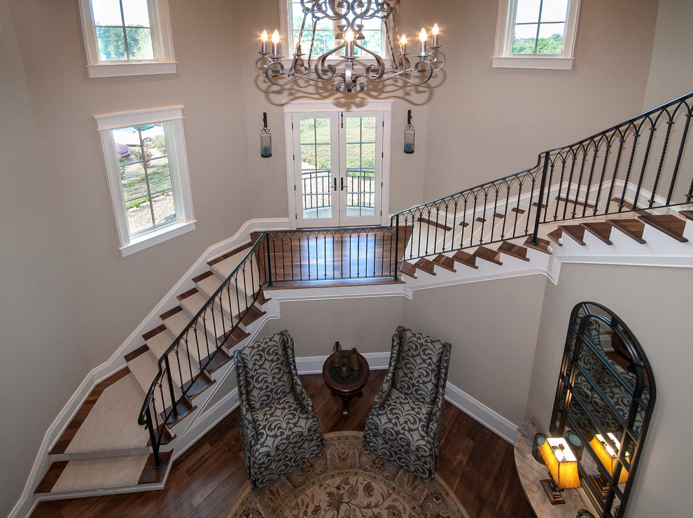 Expansive traditional wood staircase in Other with painted wood risers.