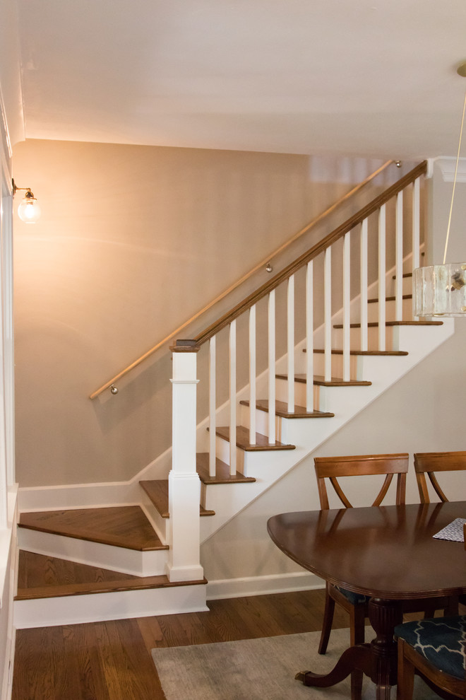 This is an example of a medium sized classic wood l-shaped wood railing staircase in Atlanta with painted wood risers.