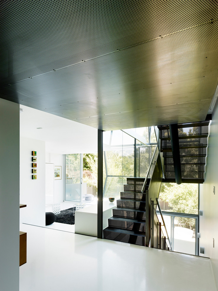 Photo of a modern metal u-shaped metal railing staircase in San Francisco with metal risers and feature lighting.