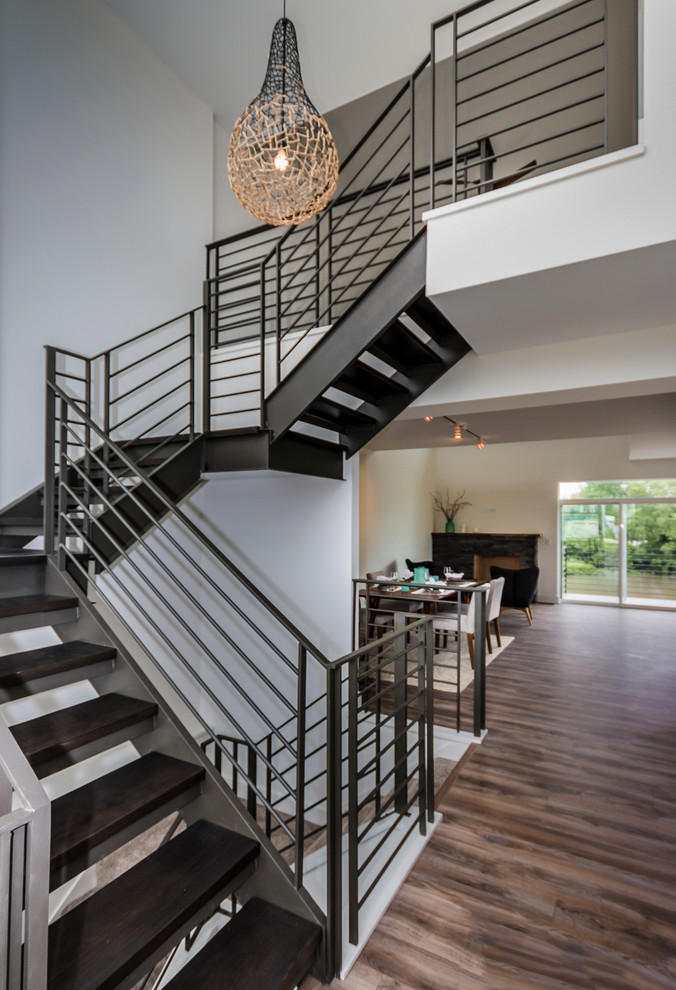Photo of a contemporary wood u-shaped staircase in Chicago with open risers.