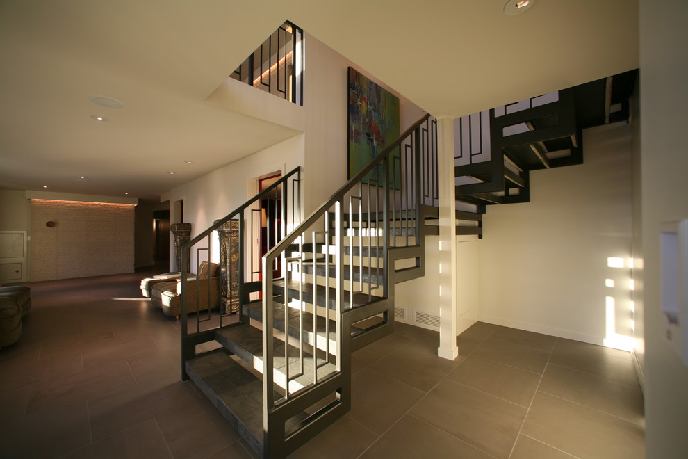 Photo of a contemporary tiled floating staircase in Portland with open risers.