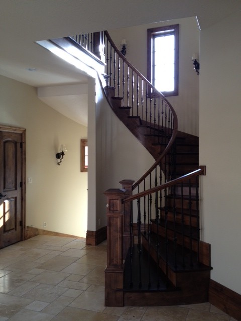 Staircase - large traditional wooden curved staircase idea in Salt Lake City with wooden risers