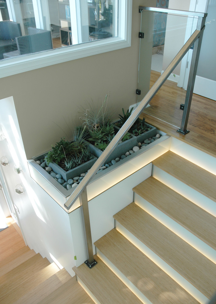 Inspiration for a contemporary wooden l-shaped staircase remodel in Santa Barbara with glass risers