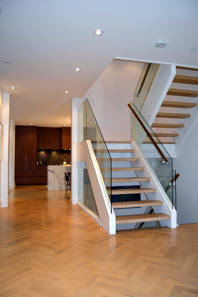 Staircase - large transitional wooden floating open staircase idea in Toronto