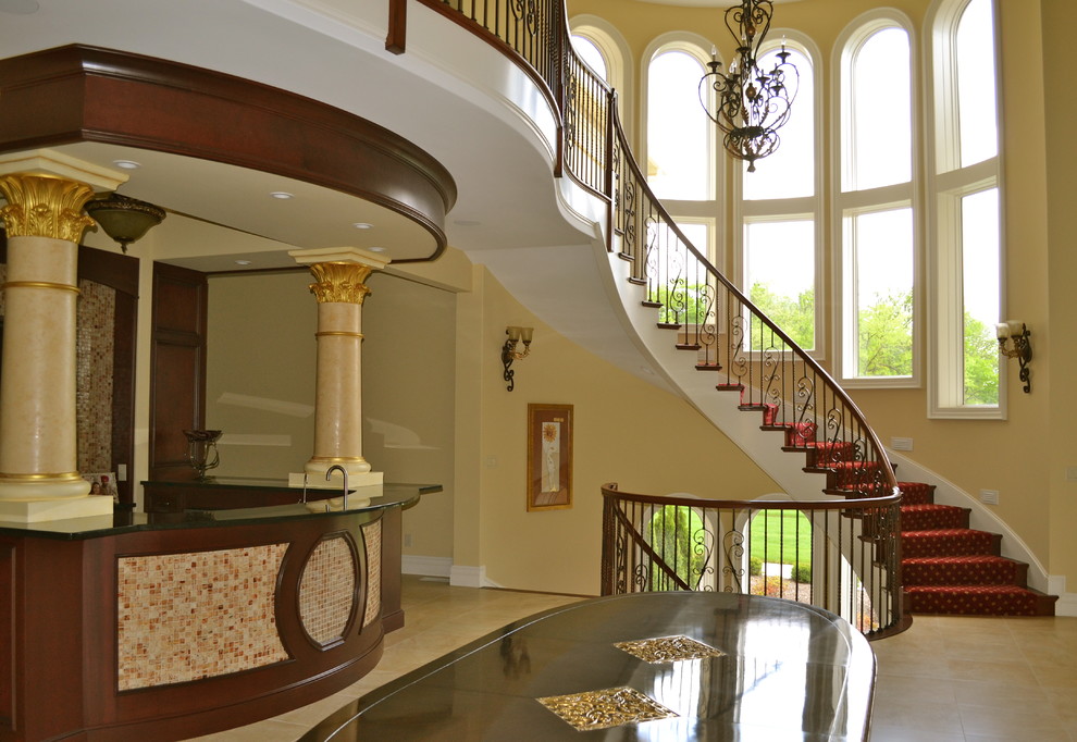 Large elegant carpeted u-shaped staircase photo in Cincinnati with carpeted risers