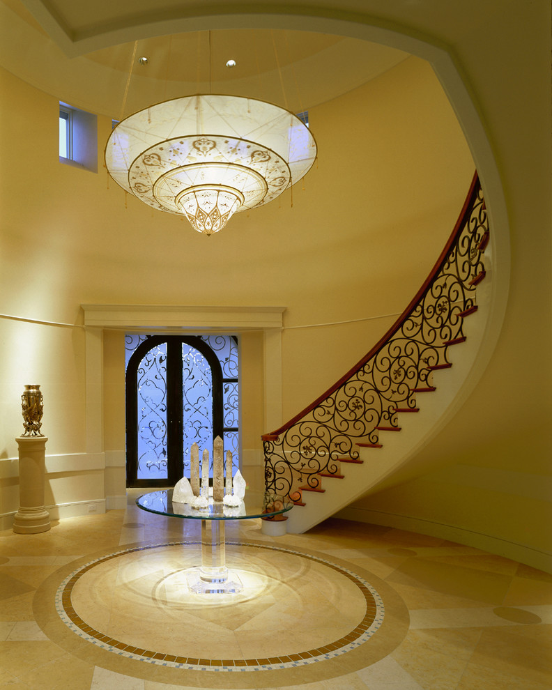 Example of a tuscan curved staircase design in Phoenix