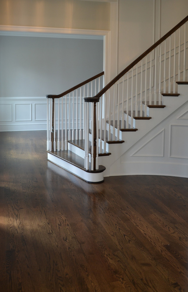 This is an example of a medium sized classic wood curved staircase in Wilmington with wood risers.