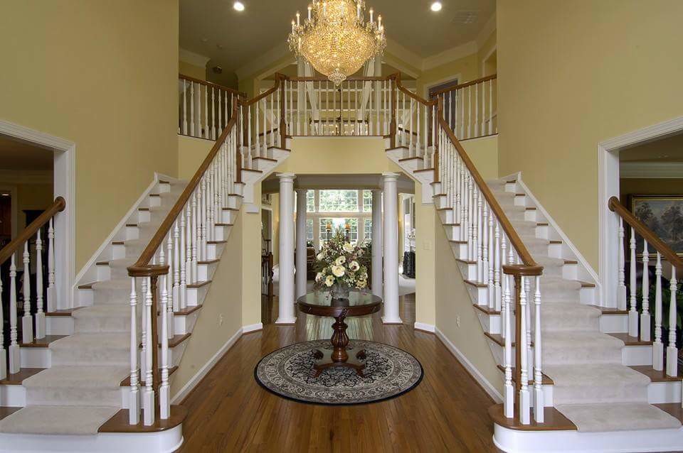 Inspiration for a large timeless wooden curved wood railing staircase remodel in DC Metro with painted risers