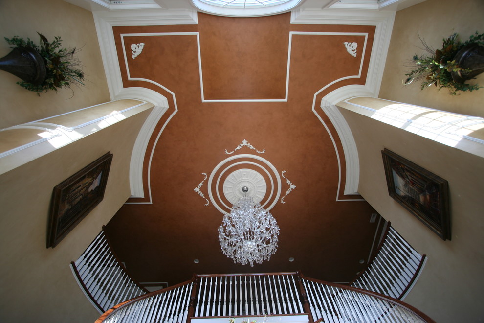 На фото: большая изогнутая лестница в классическом стиле с ступенями с ковровым покрытием и ковровыми подступенками