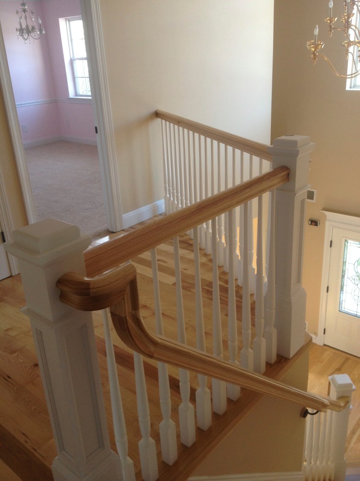 Design ideas for a medium sized classic wood l-shaped staircase in New York with painted wood risers.