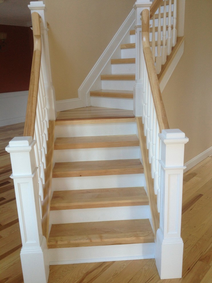 Photo of a medium sized classic wood l-shaped staircase in New York with painted wood risers.