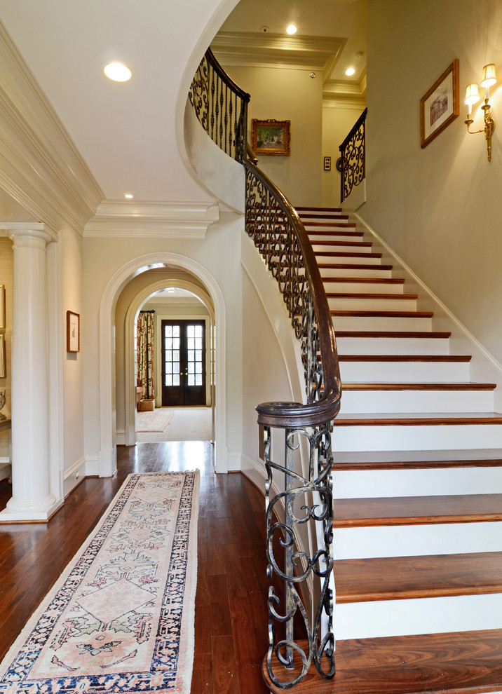 Large elegant wooden straight staircase photo in Dallas with painted risers