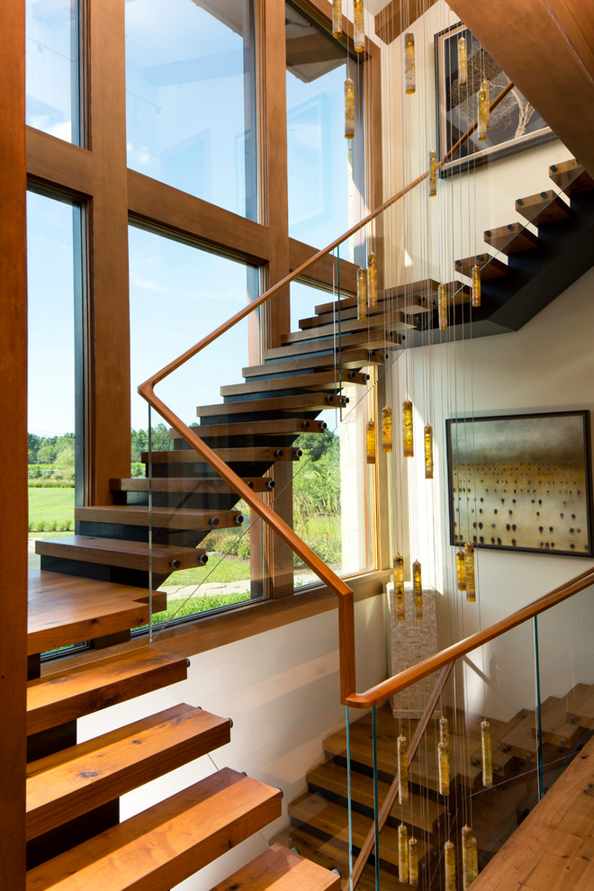 Ejemplo de escalera en U contemporánea extra grande con escalones de madera