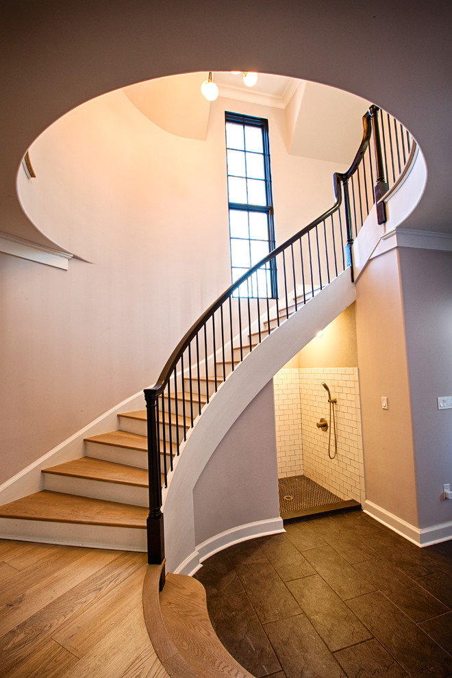 Staircase - large transitional wooden curved mixed material railing staircase idea in New York with painted risers