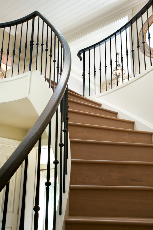 Staircase - mediterranean wooden curved mixed material railing staircase idea in Edmonton with wooden risers