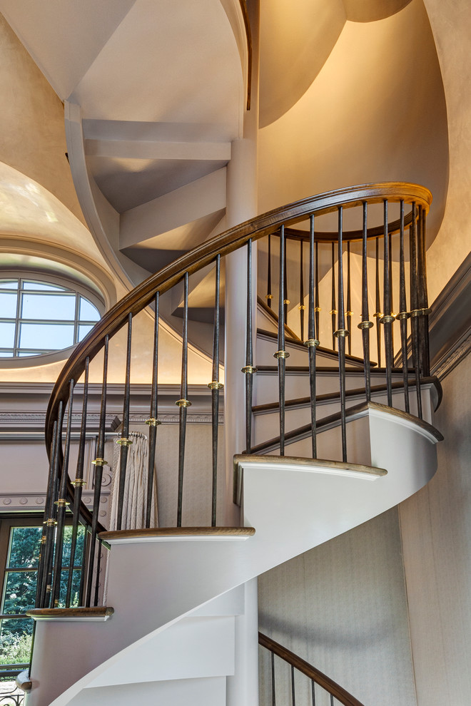 Example of a classic wooden spiral staircase design in New York with wooden risers