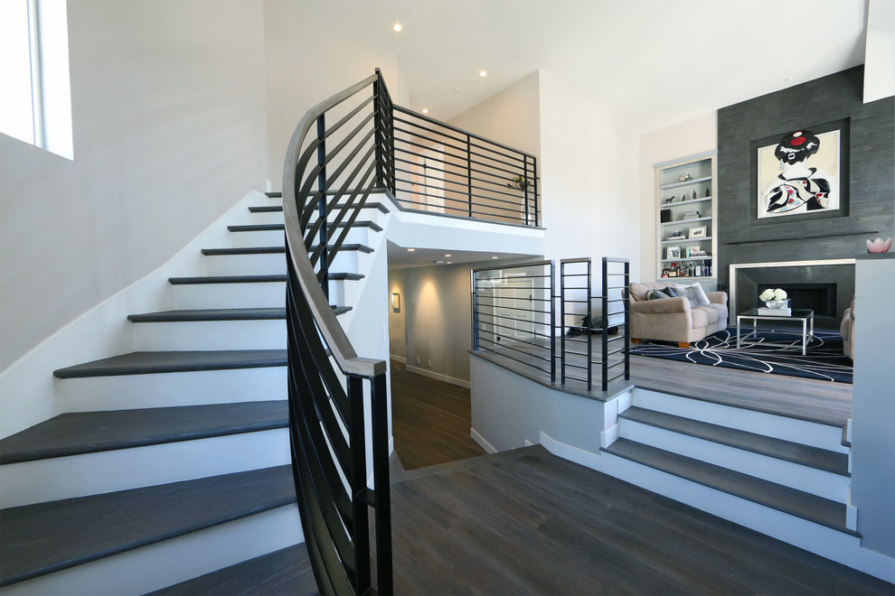 Inspiration for a transitional wooden curved staircase remodel in Los Angeles with painted risers