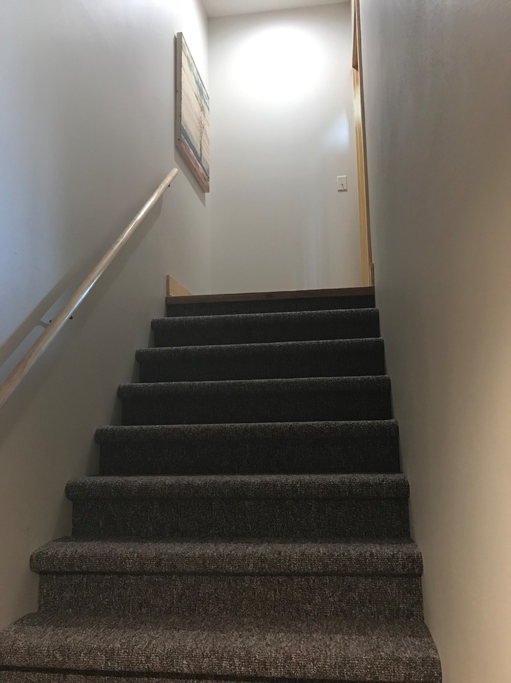 Стильный дизайн: угловая лестница в стиле рустика с ступенями с ковровым покрытием, ковровыми подступенками и деревянными перилами - последний тренд