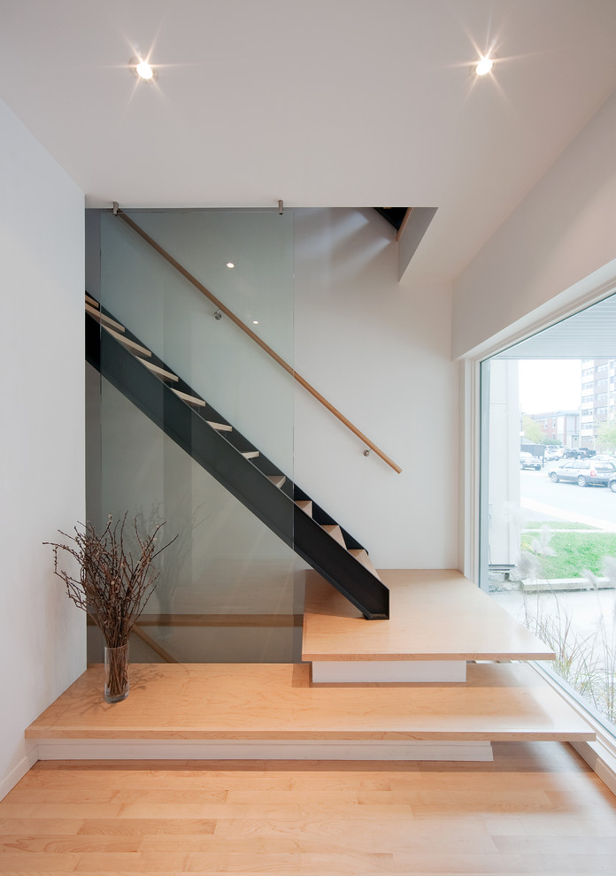 Inspiration for a contemporary wood straight staircase in Ottawa with open risers and feature lighting.