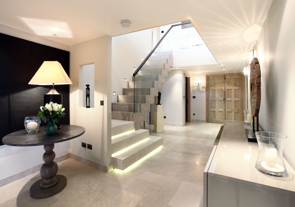 This is an example of a contemporary staircase in London with feature lighting.