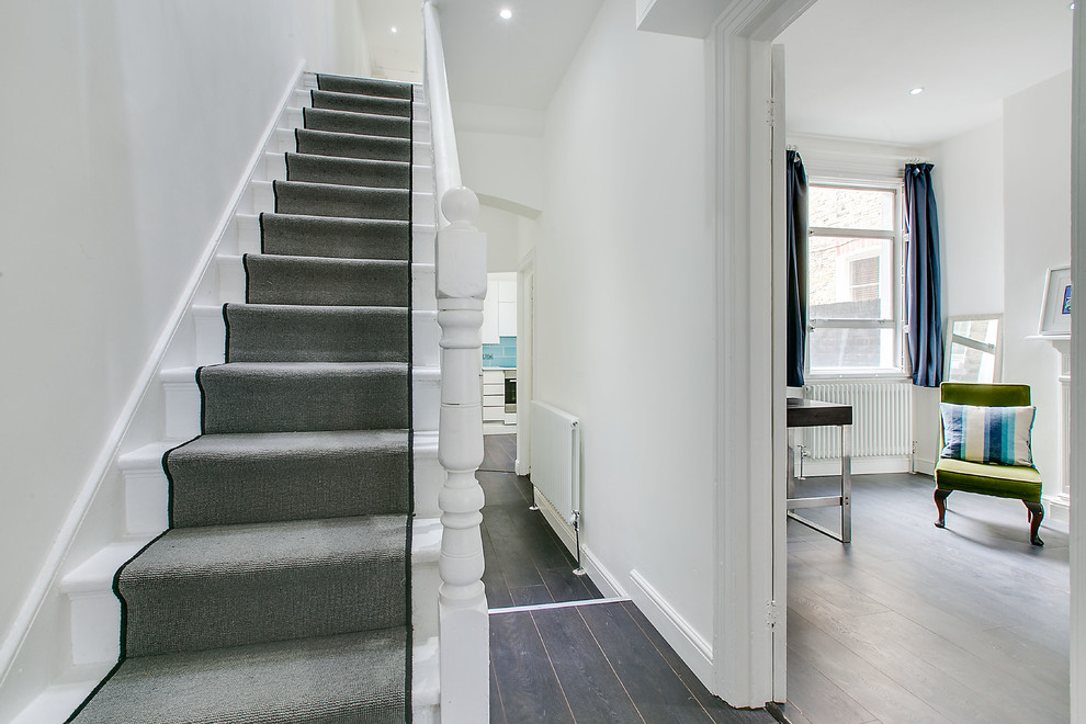 Exemple d'un escalier droit chic de taille moyenne avec des marches en moquette et des contremarches en moquette.